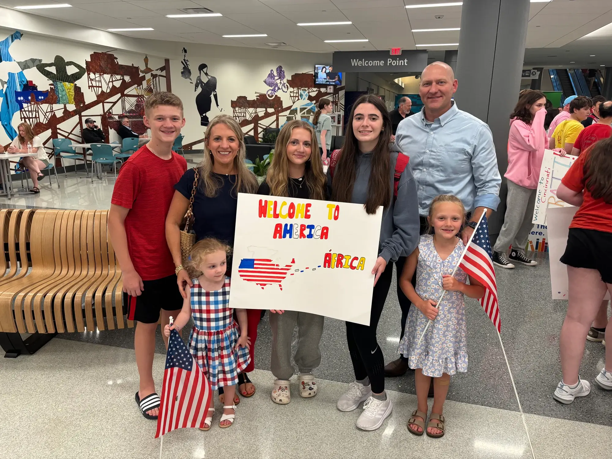A host family welcomes their student at the airport